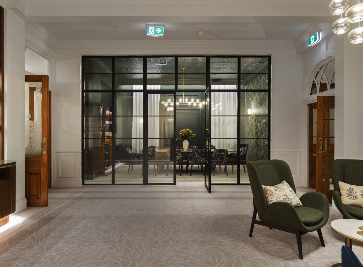 A classic Beaux Arts private dining room with modern glass partitions at The Clements Hotel, Waikato.