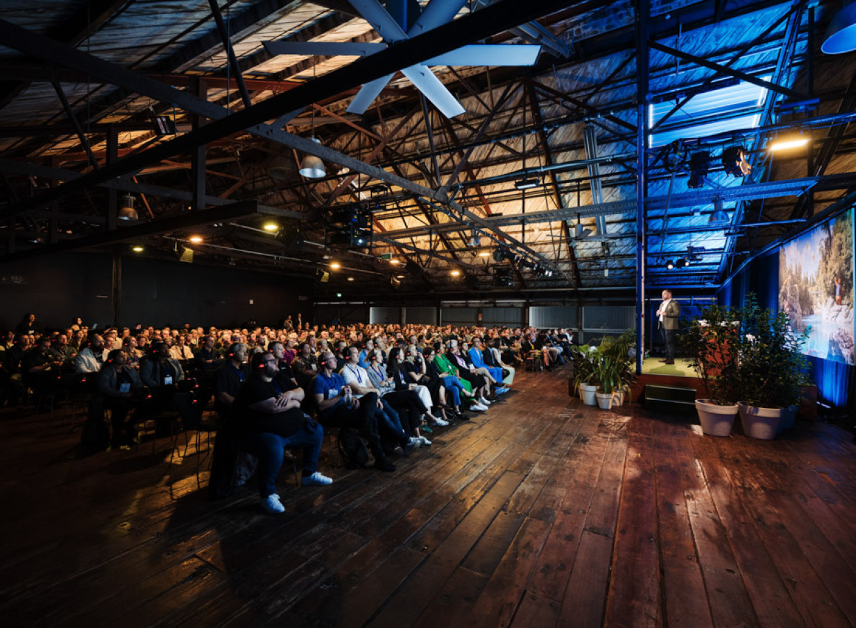A presentation within the industrial-chic, heritage-listed Shed 10 in Auckland, showcasing its exposed beams and timber floors.