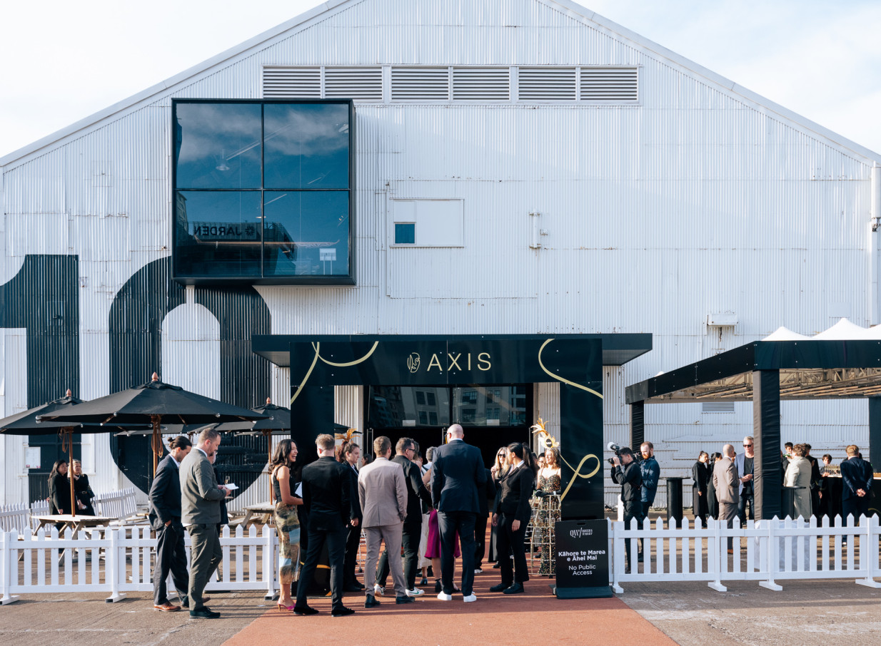 Guests gather outside the industrial-chic Shed 10 in Auckland, a historic corrugated iron event venue.