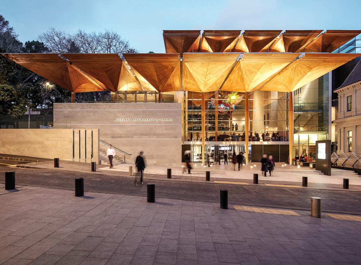 The contemporary entrance of the Auckland Art Gallery Toi o Tāmaki features distinctive timber canopies and glass.