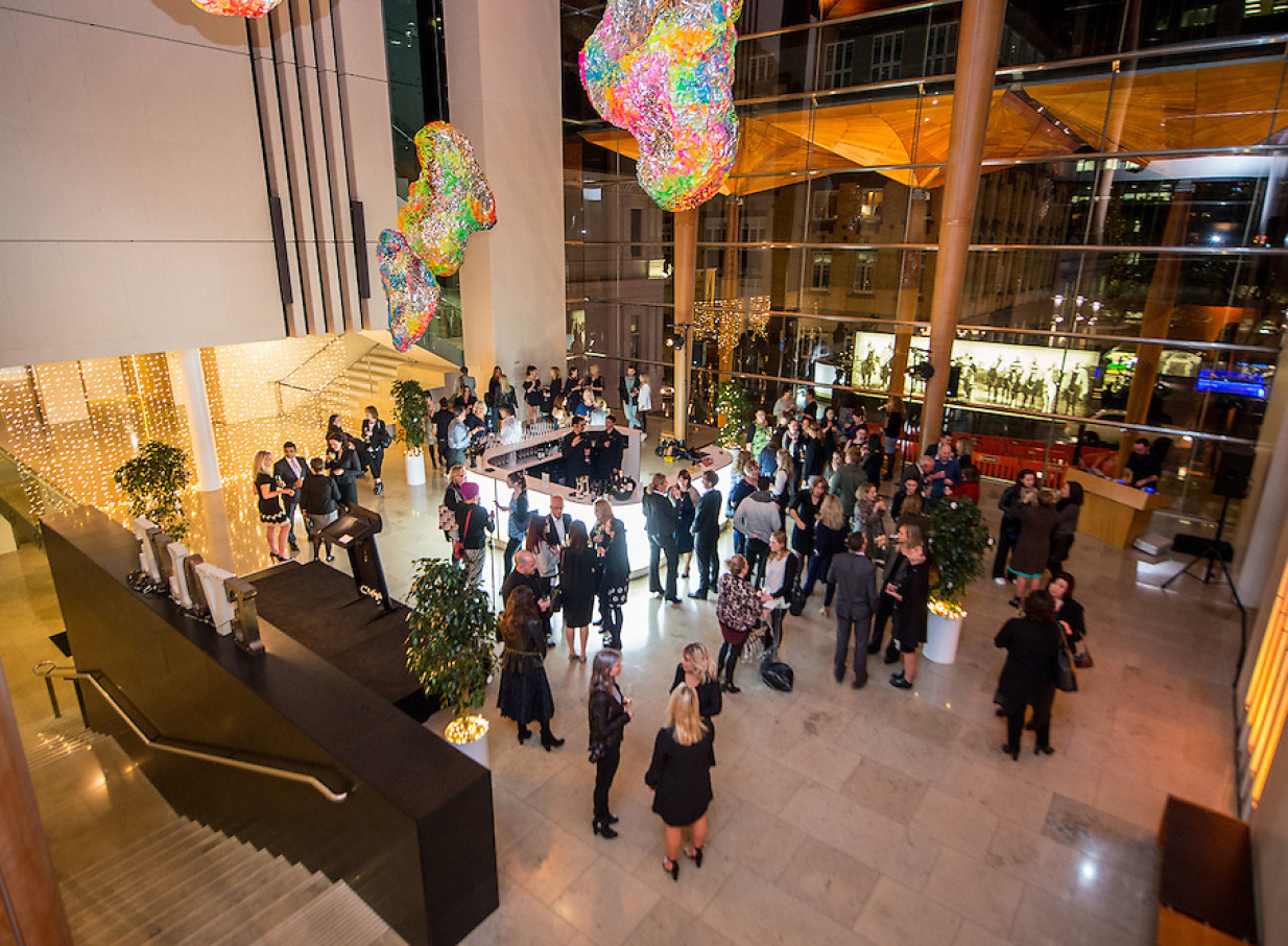 Guests enjoy a cocktail function in Auckland Art Gallery's modern atrium, blending heritage with award-winning contemporary architecture.