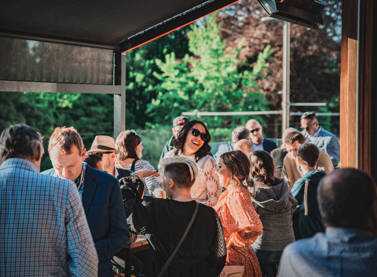 A lively gathering enjoying the vibrant jazz club outdoor patio at Fat Eddie's in Christchurch.