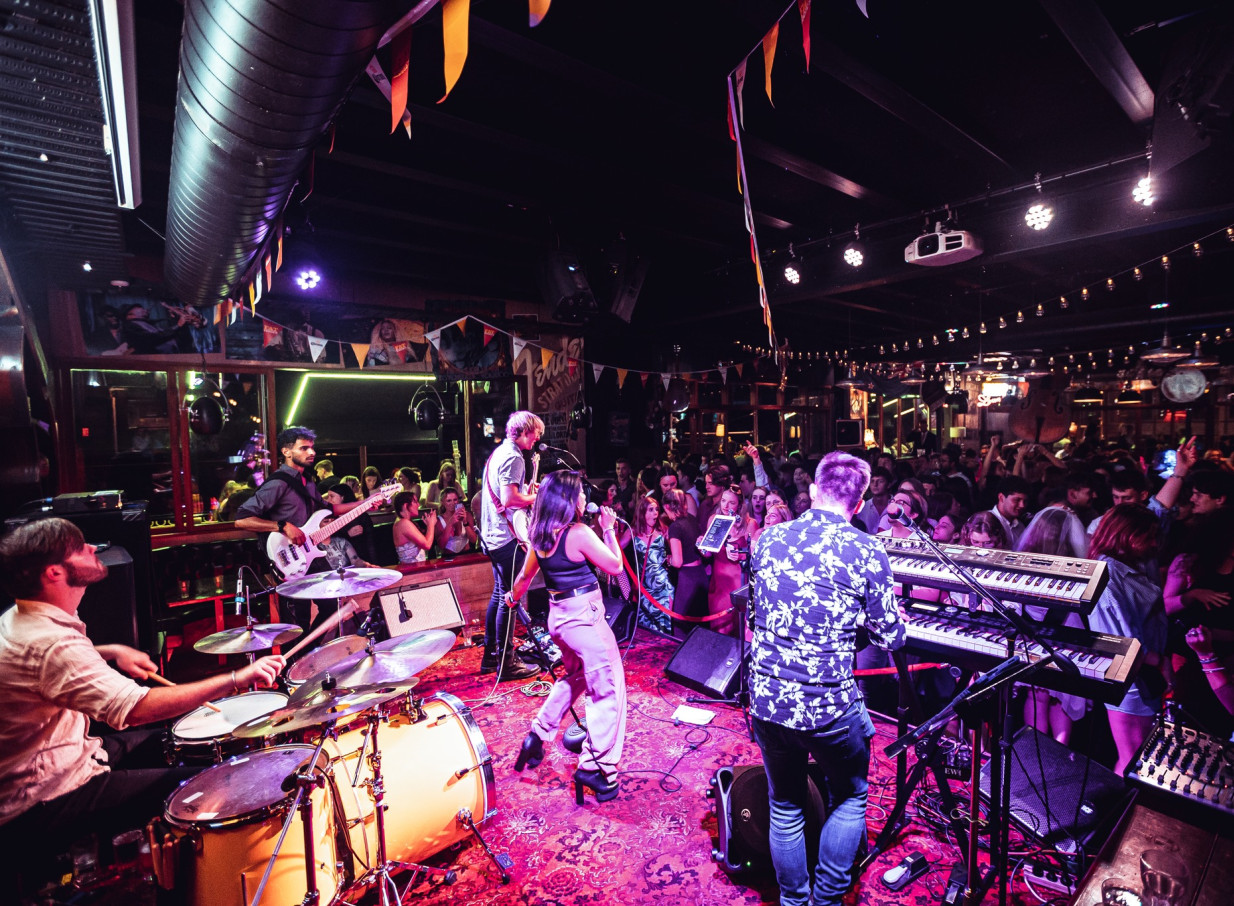 A live band performs for a lively crowd in Fat Eddie's, a vibrant Christchurch jazz and live music venue.