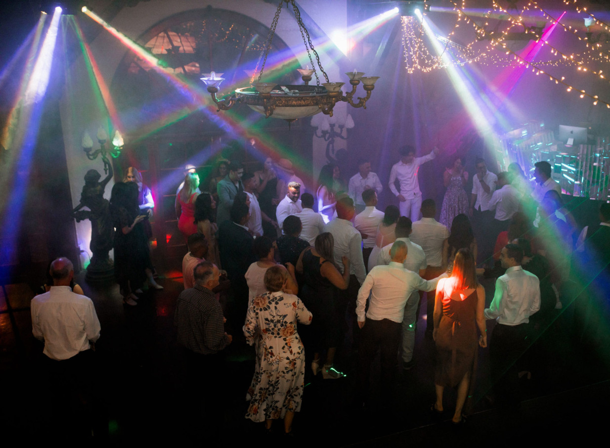 Guests enjoy a lively dance floor in the vintage-style banquet hall at Settlers Country Manor, Auckland.