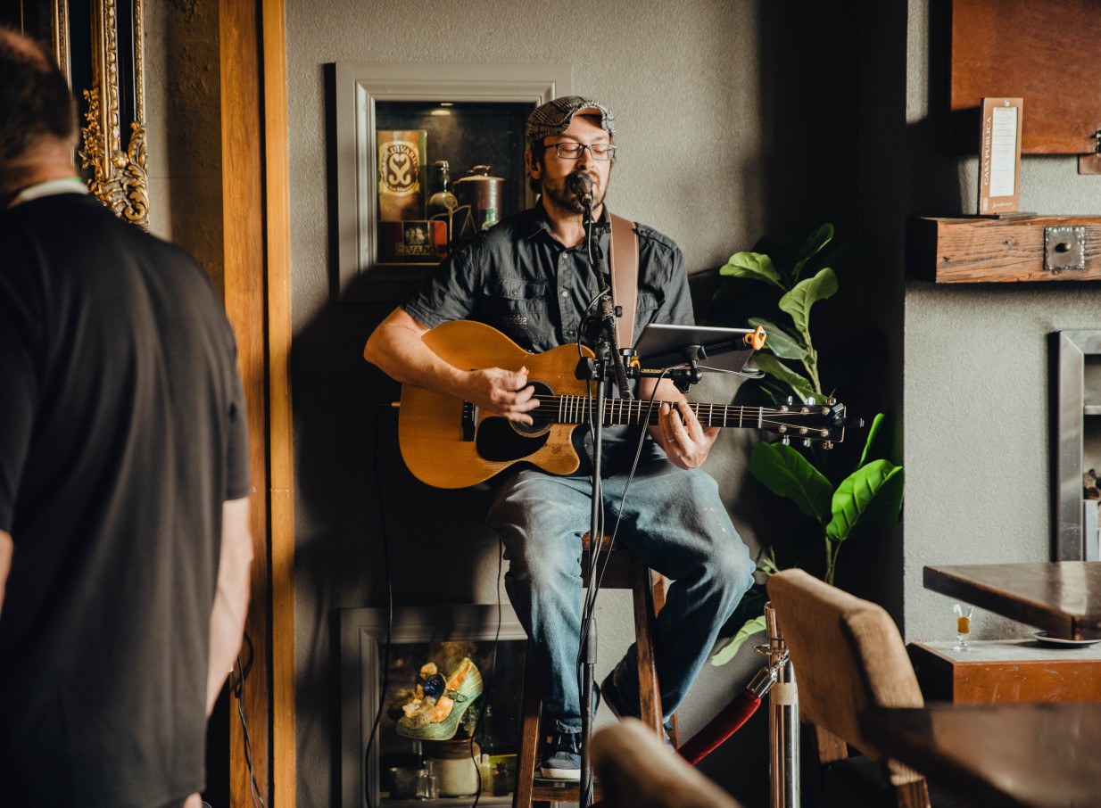 An intimate live music performance by a guitarist at the South American-inspired Casa Publica in Christchurch.