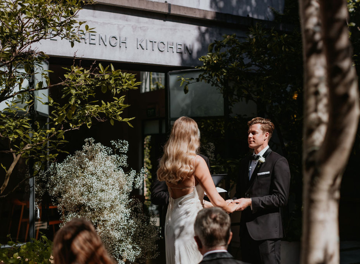 An outdoor ceremony at The French Cafe Auckland's elegant French quarter-inspired courtyard.