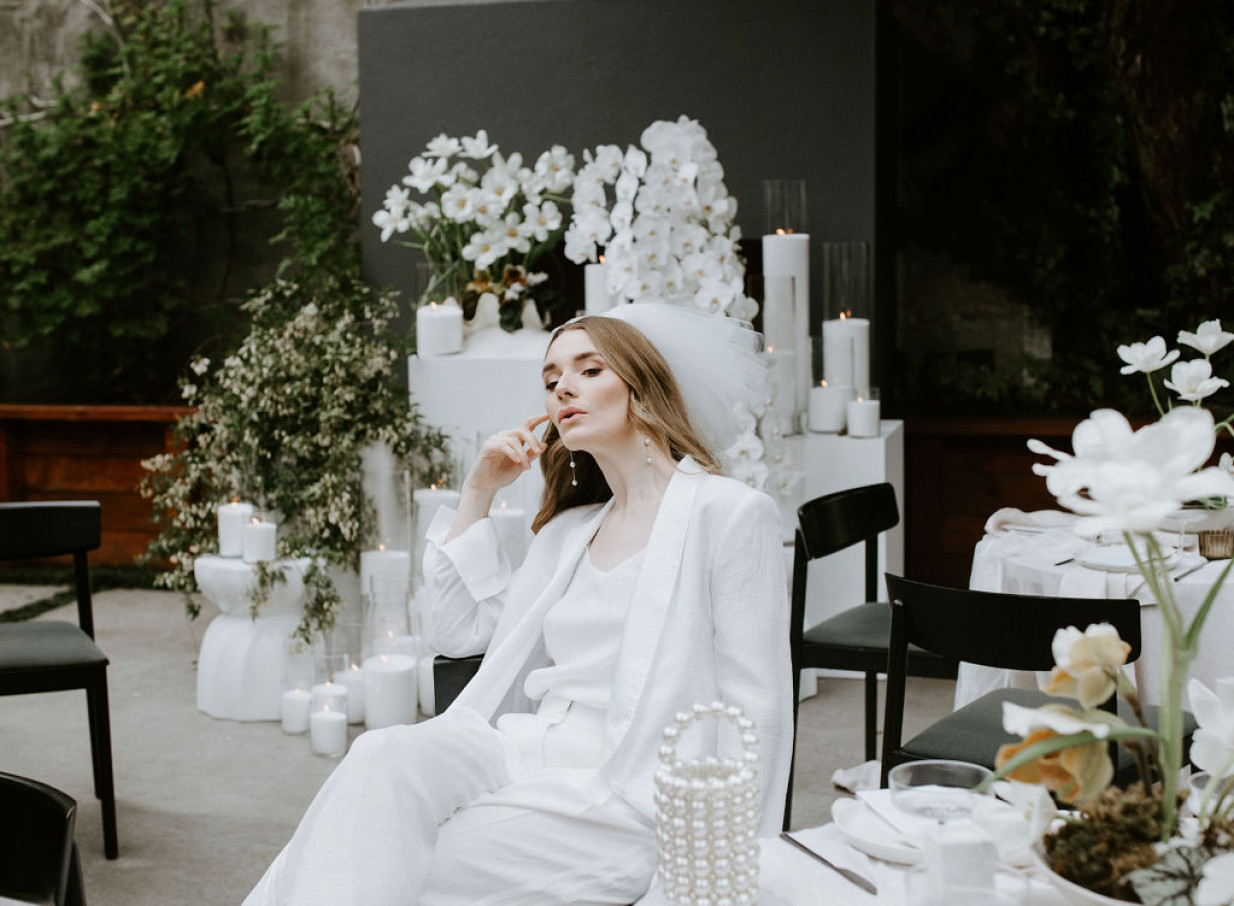 The French Cafe Auckland's elegant, French-inspired private event space features refined white florals and abundant candlelight.