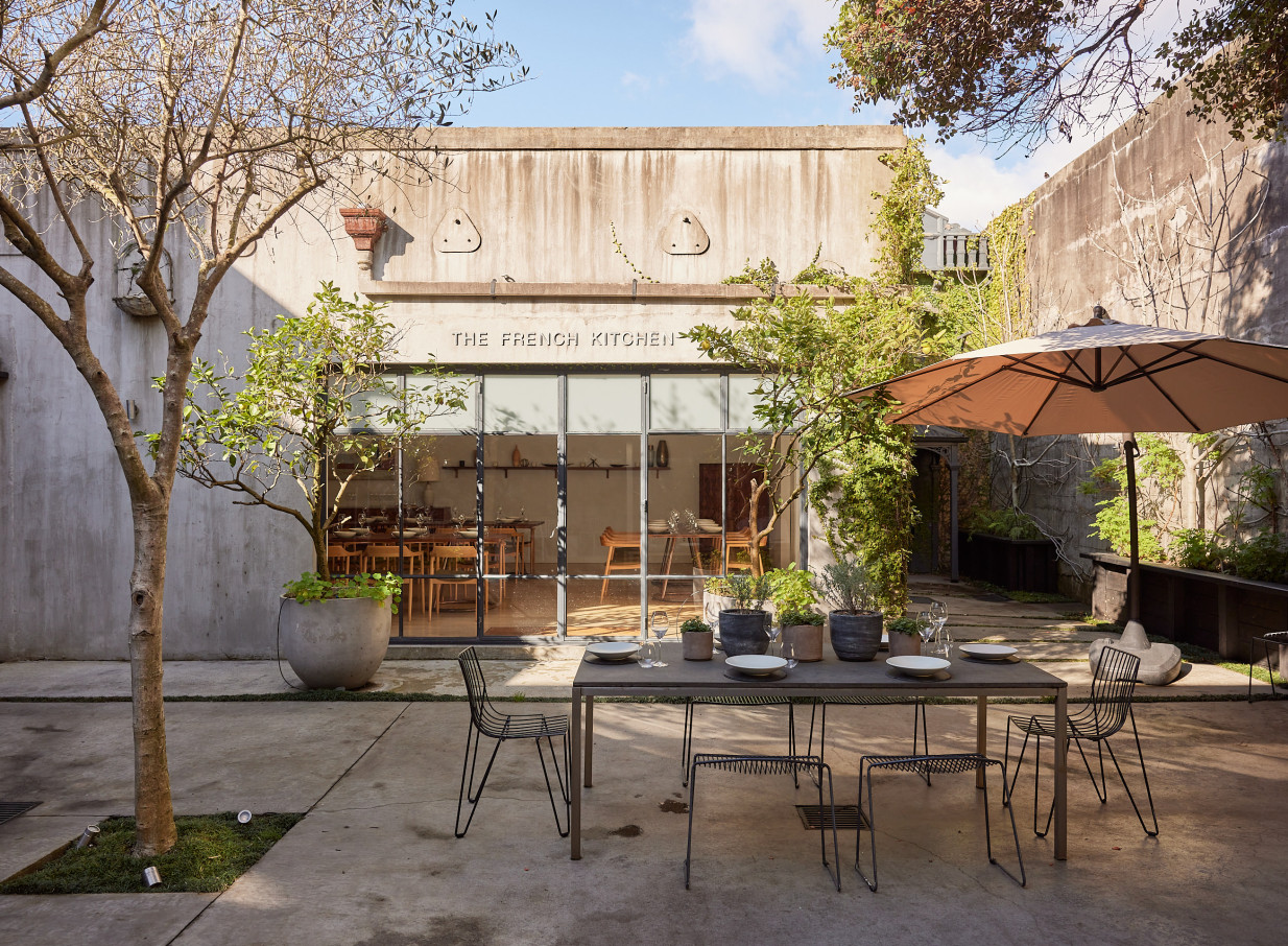An outdoor dining area in The French Cafe's romantic European-inspired courtyard in Auckland.