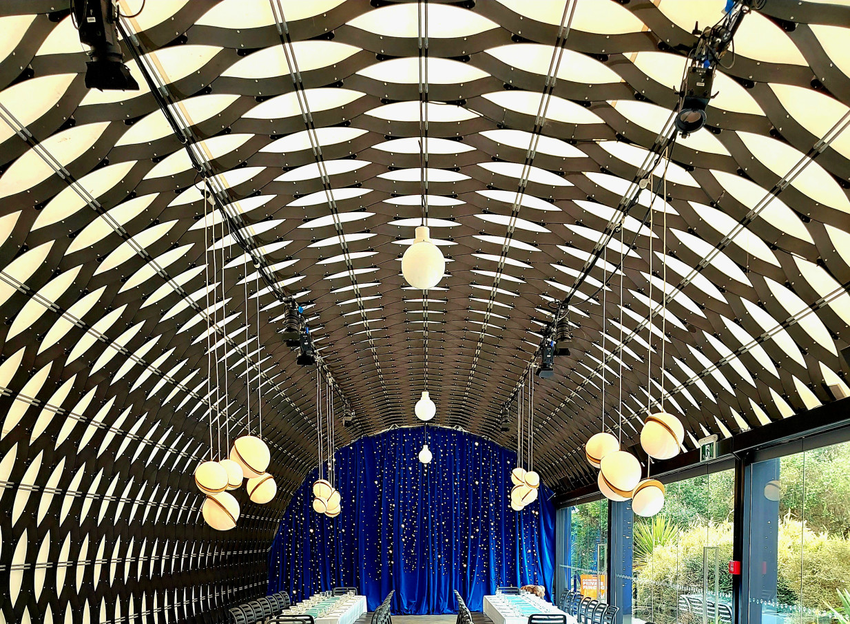 Kamala's, an architecturally award-winning event space at Te Nukuao Wellington Zoo, featuring a distinctive arched ceiling and banquet setup.
