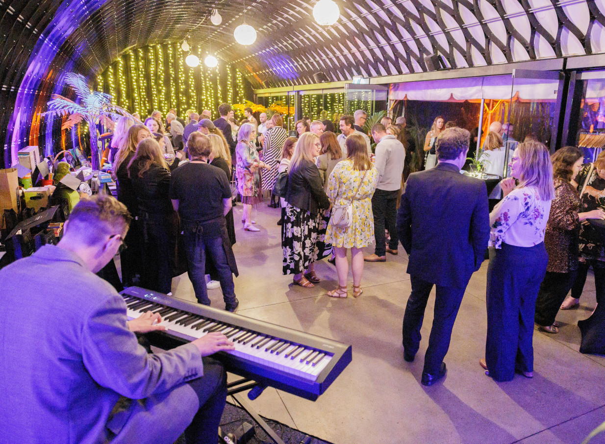 Guests enjoy live music and mingle in the barrel-vaulted Kamala's event pavilion at Te Nukuao Wellington Zoo.