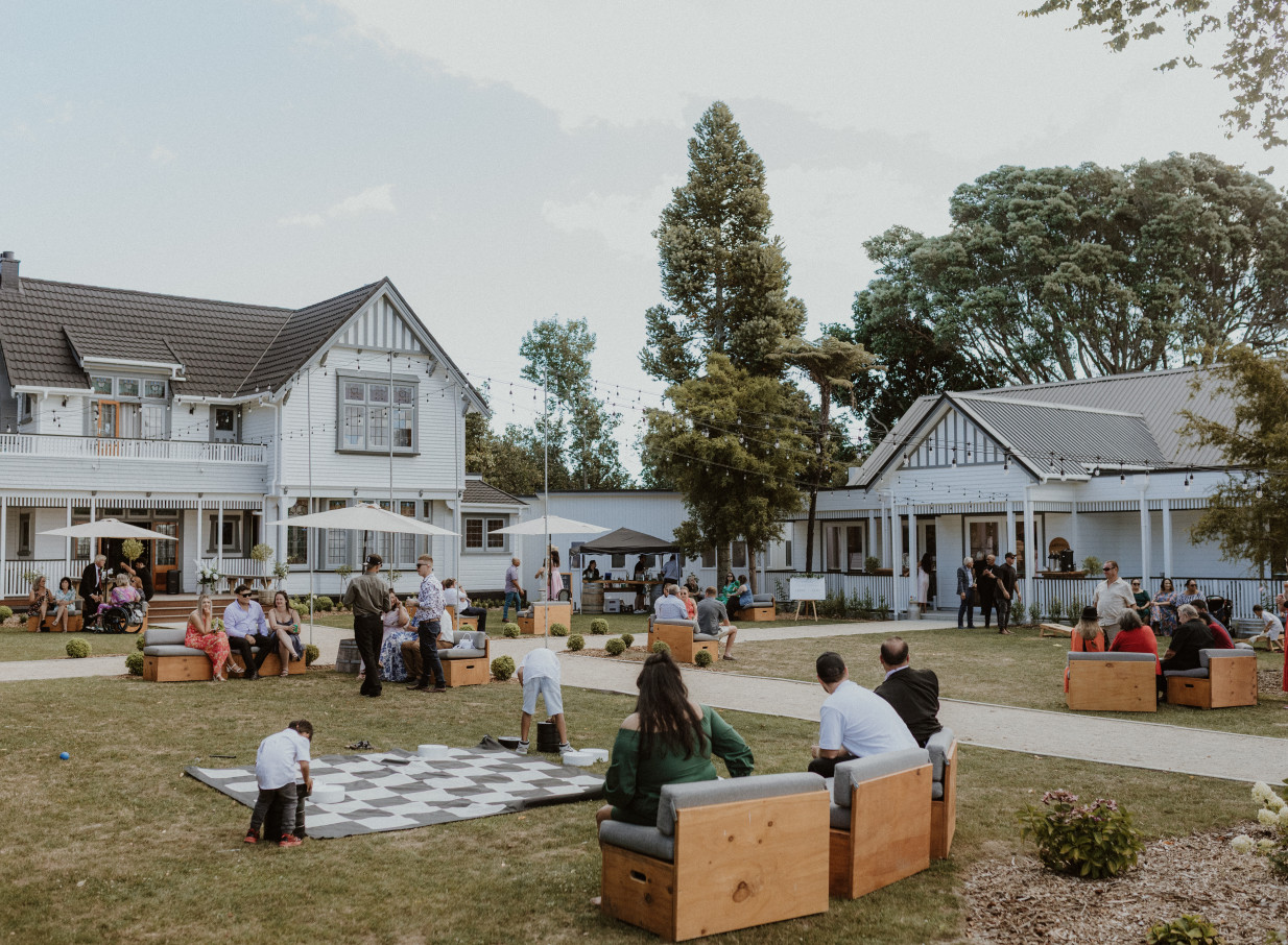 A vibrant outdoor gathering with games on the lawn at Tatum, a historic homestead venue in Manawatū-Whanganui.