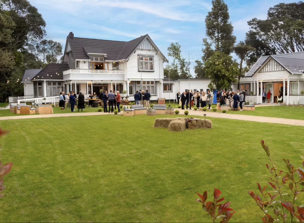 An outdoor reception unfolds on the lawn of Tatum, a heritage-rich 1912 homestead venue in Manawatū-Whanganui.