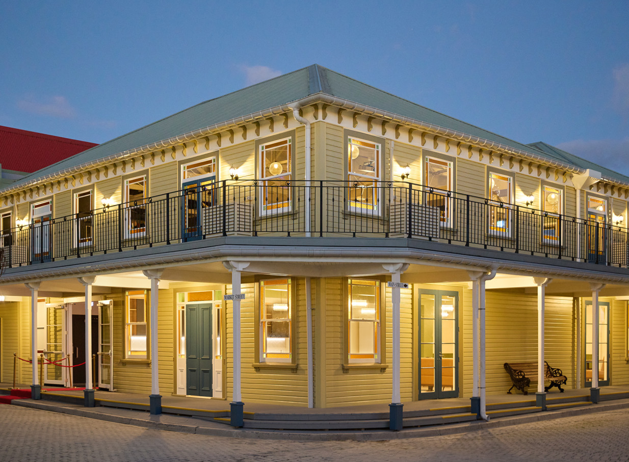 The Historic Village, Tauranga, showcases its quaint, early settler style building with a welcoming evening glow.