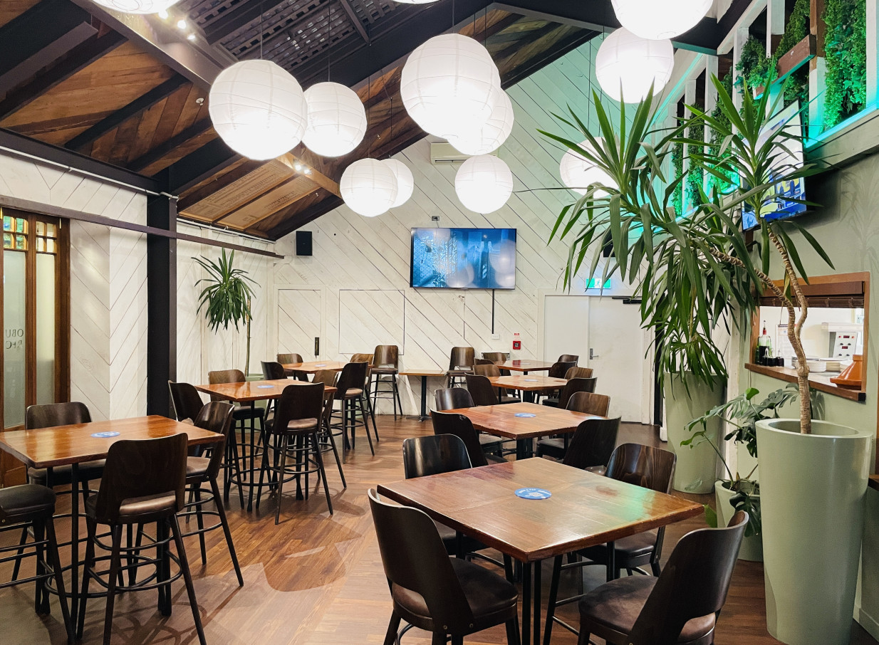 Wellington's historic Cambridge Hotel features a traditional pub dining room with wooden tables and spherical lanterns.