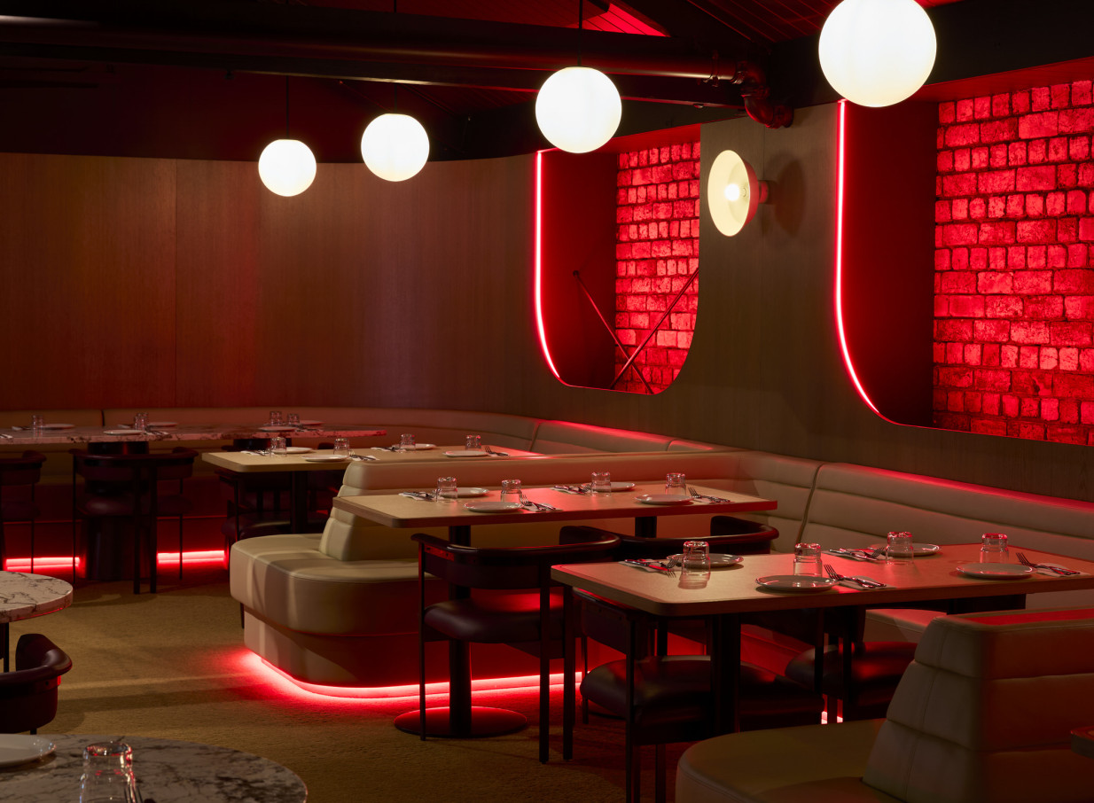 Neon lighting over booths at Darling on Drake