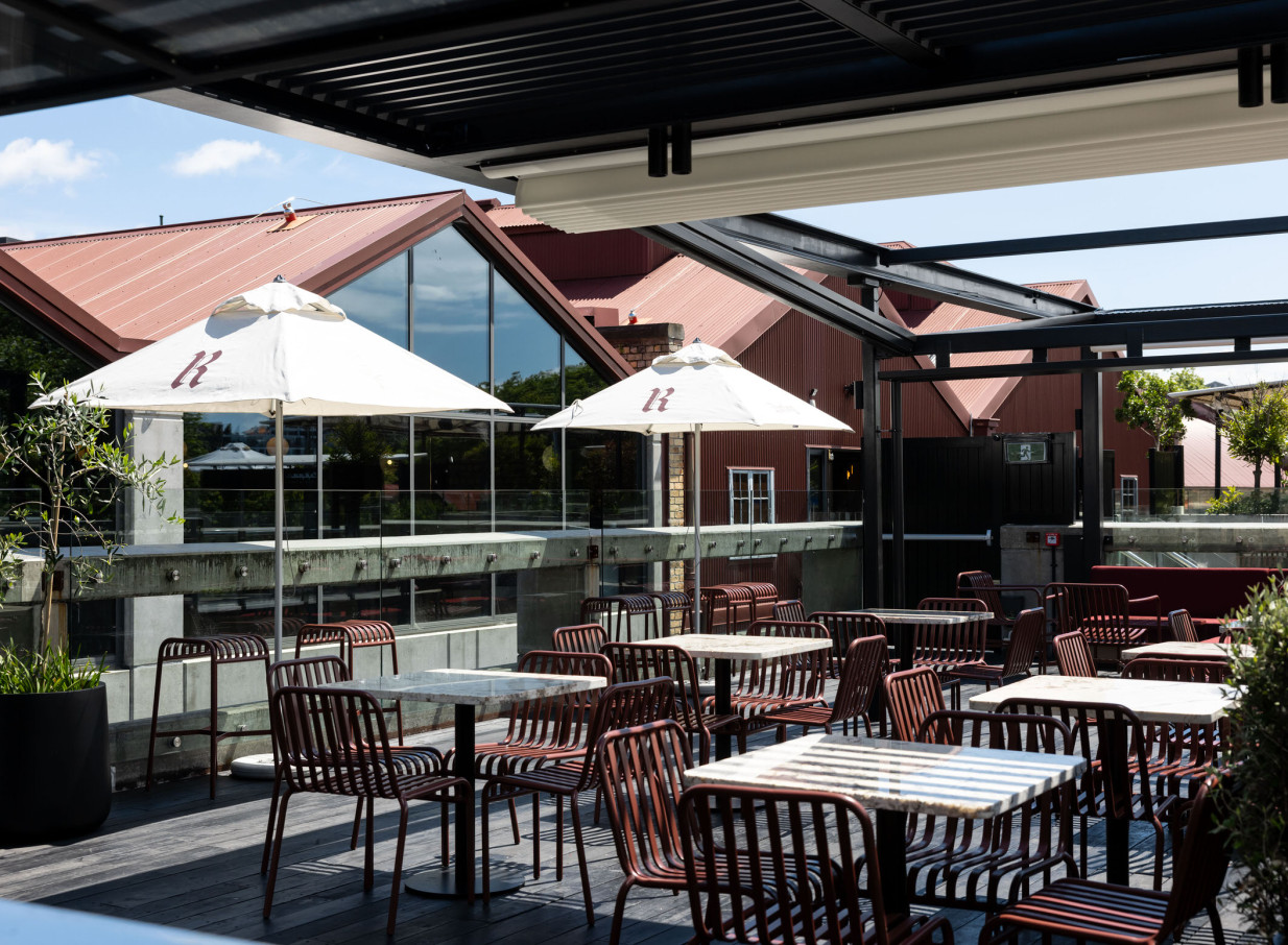 Rooftop bar with umbrellas at Darling on Drake