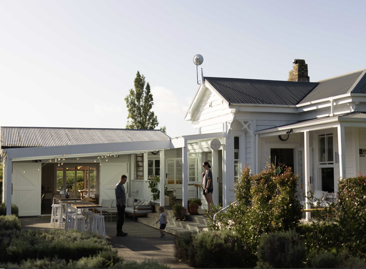 Outdoor dining at the charming white villa of Farm House Cafe in Auckland.
