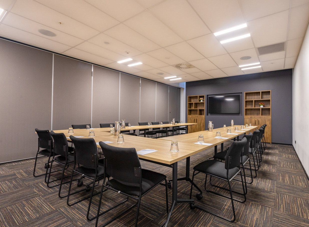 A modern meeting room, set up in a U-shape, at the contemporary Oaks Wellington Hotel.