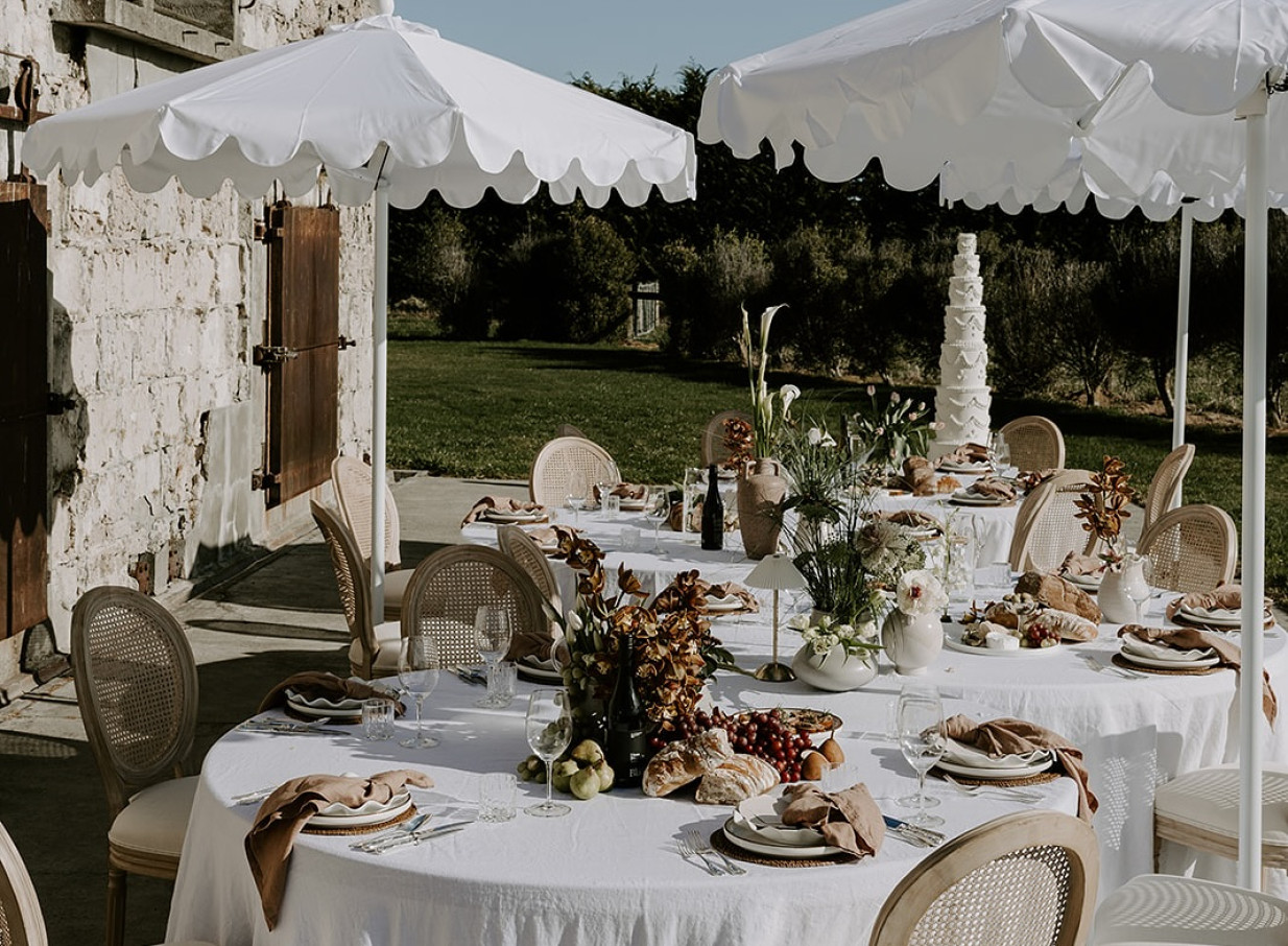 An elegant outdoor dining area at The Flaxmill, Christchurch, showcasing its rustic heritage.
