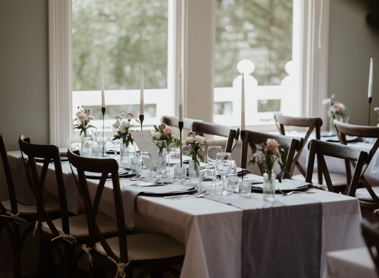 An elegant dining space within the historic Victorian Gear Homestead in Wellington, featuring a beautifully set table.