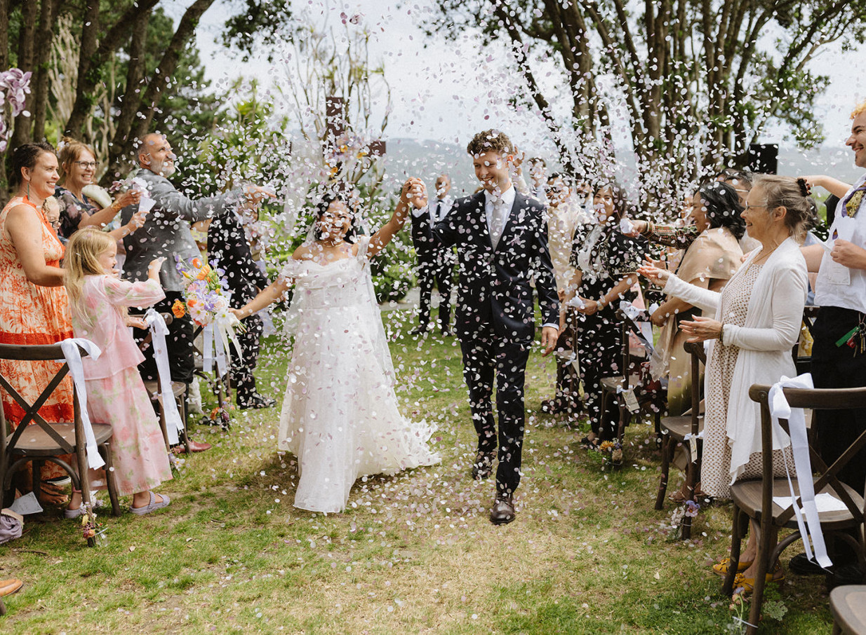A joyful wedding confetti exit in the beautiful garden setting of Gear Homestead, a historic Victorian homestead in Wellington.