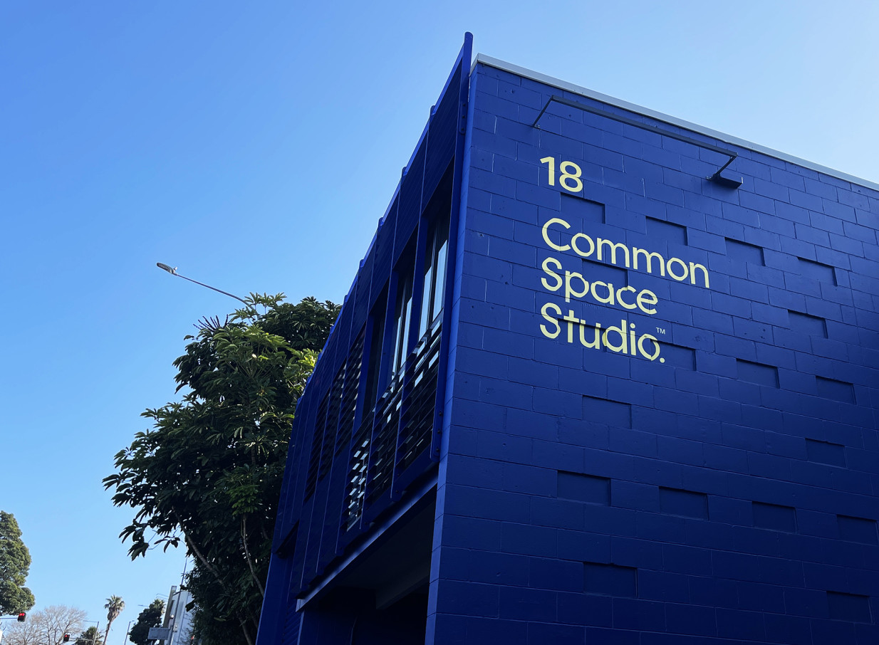 Common Space Studios in Auckland features a modern, vibrant blue exterior with bold yellow branding for its creative studio space.