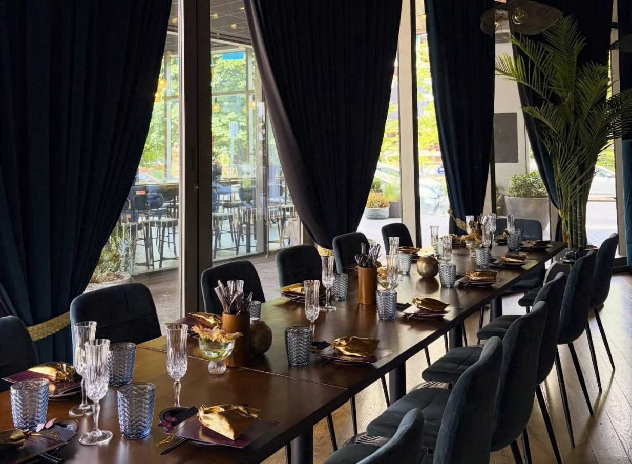 A vibrant Pacifica glam private dining room at Manu Restaurant & Bar in Christchurch, featuring deep blue curtains and elegant gold accents.