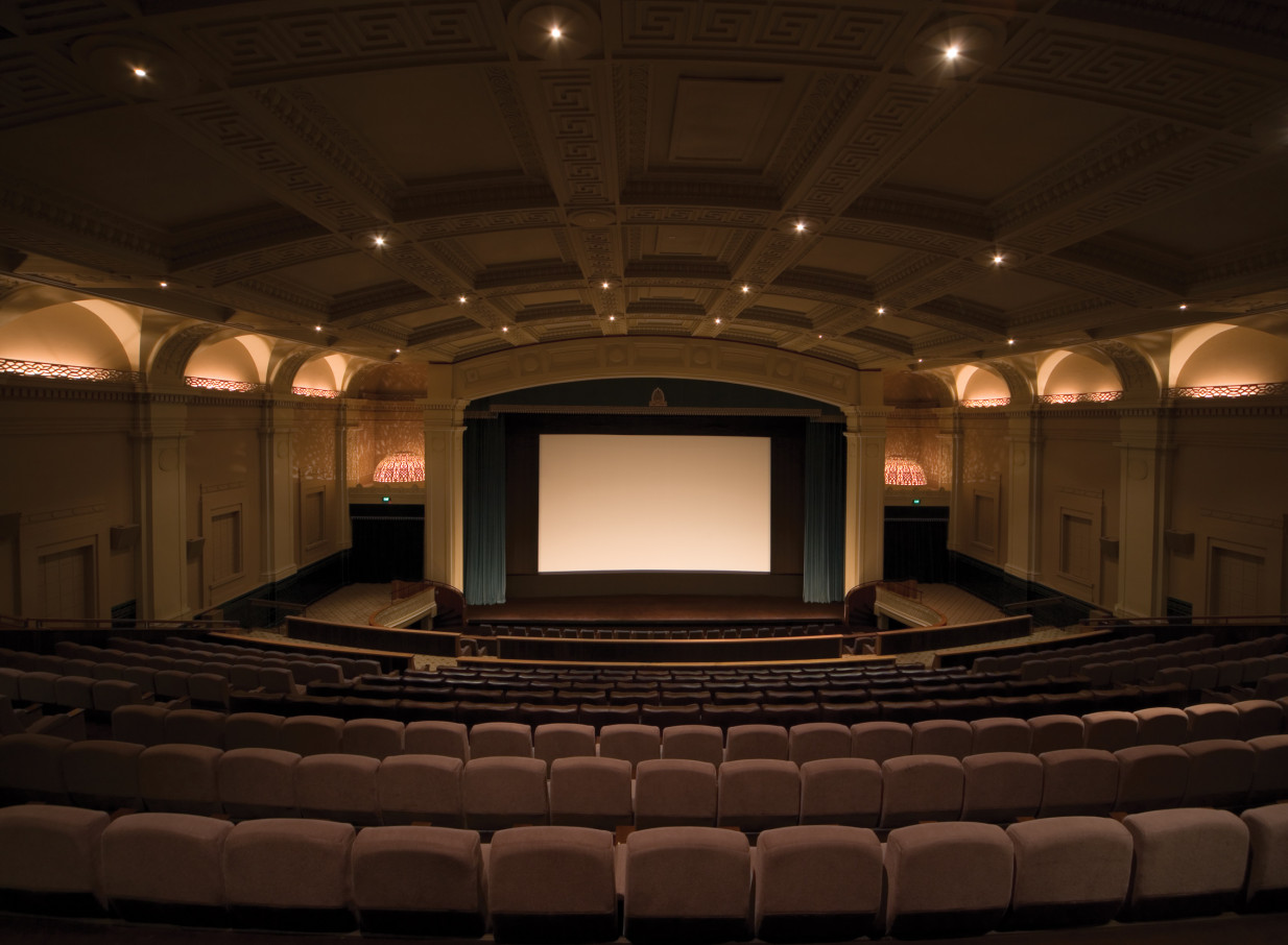 The classical Greek-revival auditorium of Event Cinema Embassy Theatre, Wellington, featuring rows of seating and a large screen.