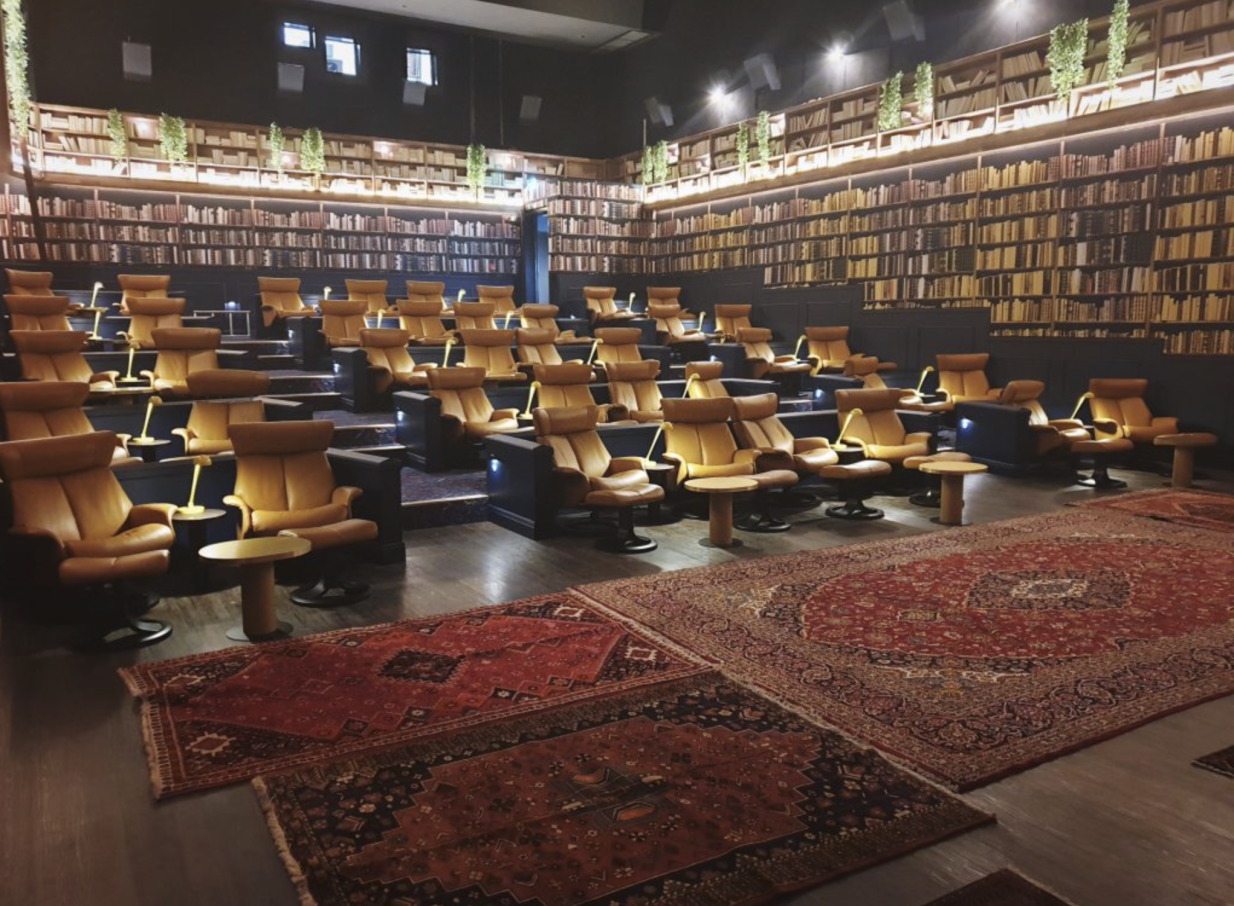 The luxurious "The Library" boutique cinema at Event Cinemas Westfield Newmarket, Auckland, features plush recliners and bookshelf-lined walls.
