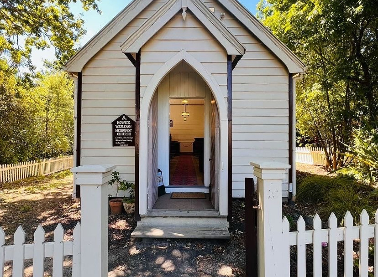 The Howick Wesleyan Methodist Church, an early colonial wooden building, stands with an arched entrance at Howick Historical Village, Auckland.