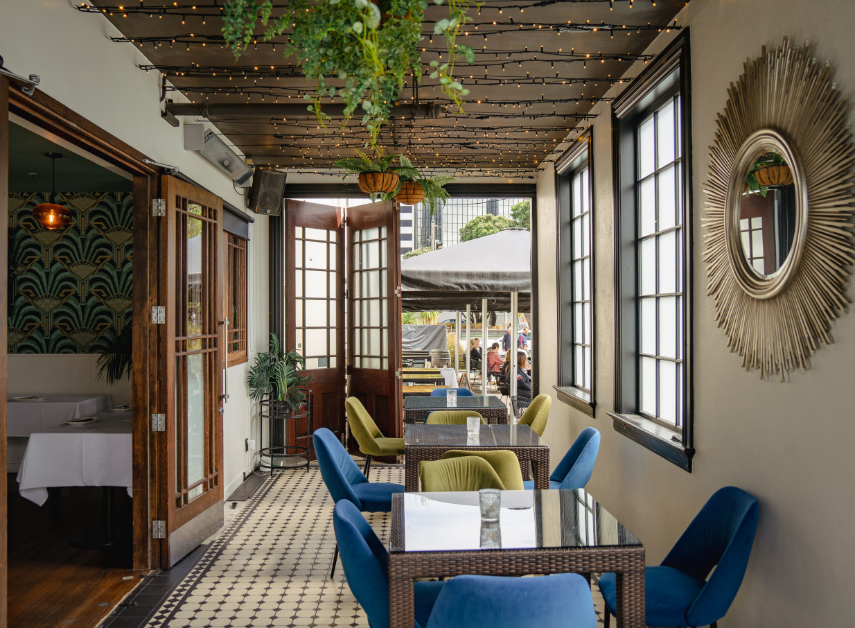 St Johns Bar & Eatery in Wellington presents a stylish Art Deco outdoor dining area with inviting seating and fairy lights.