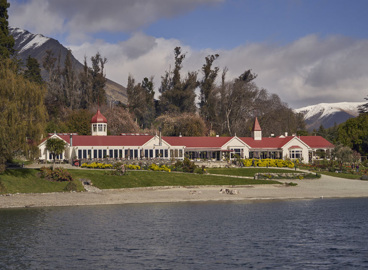 Walter Peak High Country Farm's colonial Colonel's Homestead Restaurant, with its red roof, sits by Lake Wakatipu in Queenstown.