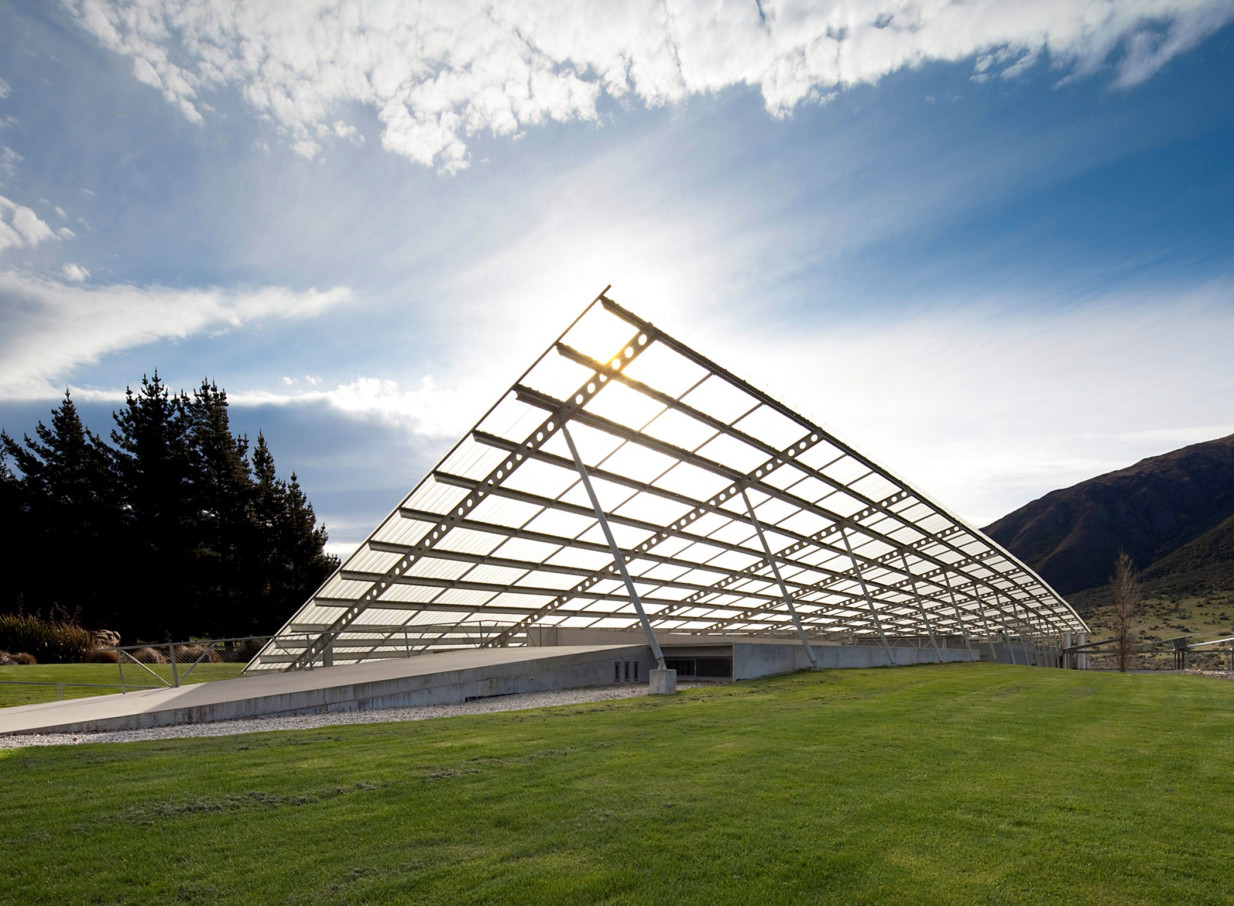 Peregrine Winery in Queenstown showcases its iconic modern architecture with a sweeping, translucent, falcon's wing-inspired roof.