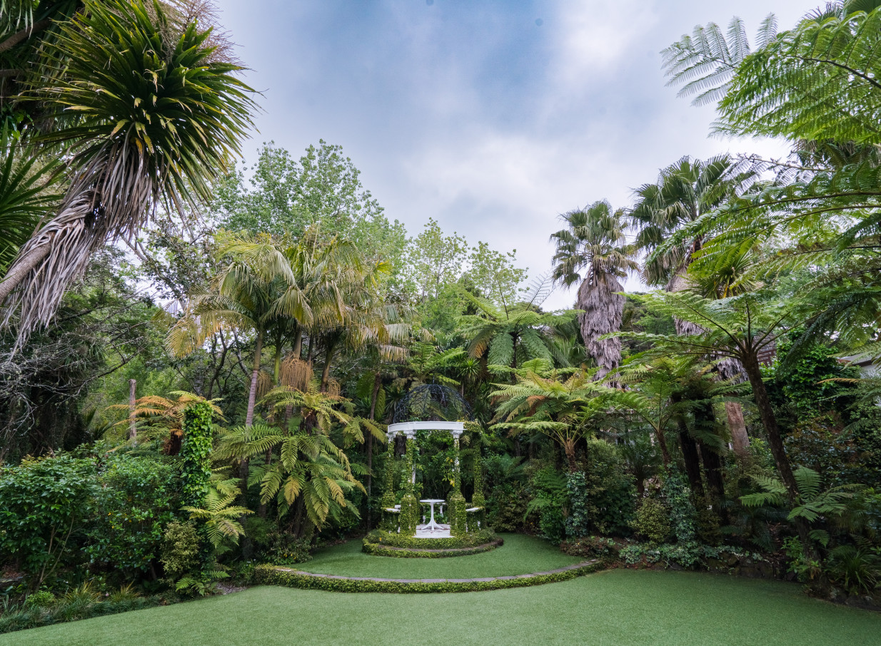 Tui Hills, Auckland offers a serene outdoor ceremony space in its enchanting native garden with a classic white gazebo.