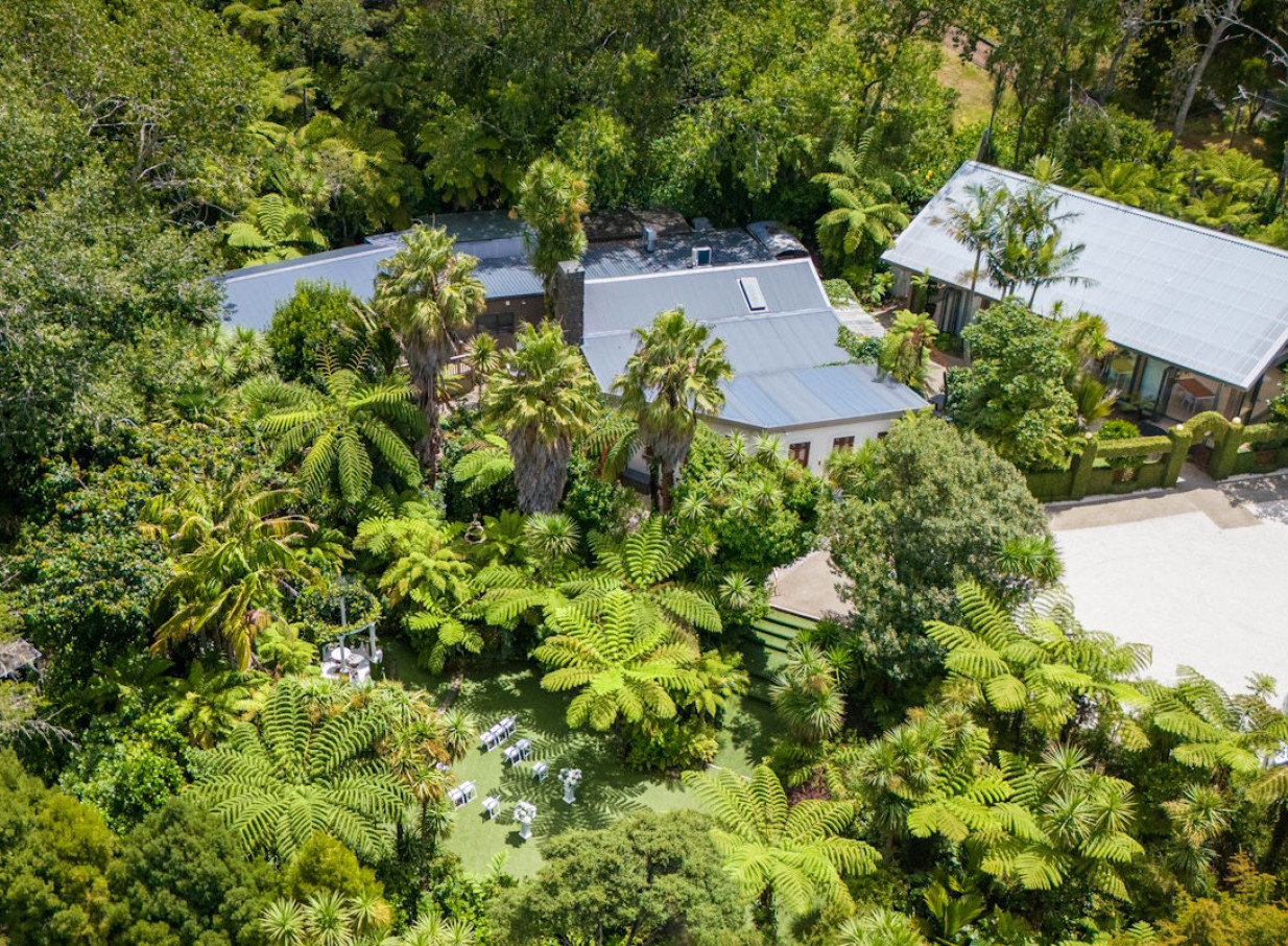 Tui Hills, Auckland, features a serene outdoor ceremony setup in its modern, nature-inspired venue amidst lush native bush.