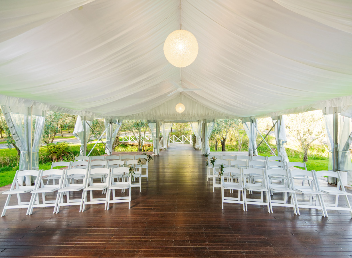A Mediterranean-inspired tented ceremony area at Bracu Estate in Auckland, surrounded by olive groves.