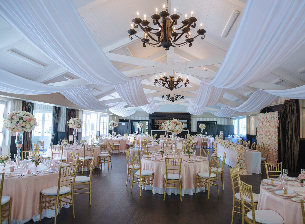 An elegant, Mediterranean-inspired indoor reception room at Bracu Estate in Auckland, set for a grand event.