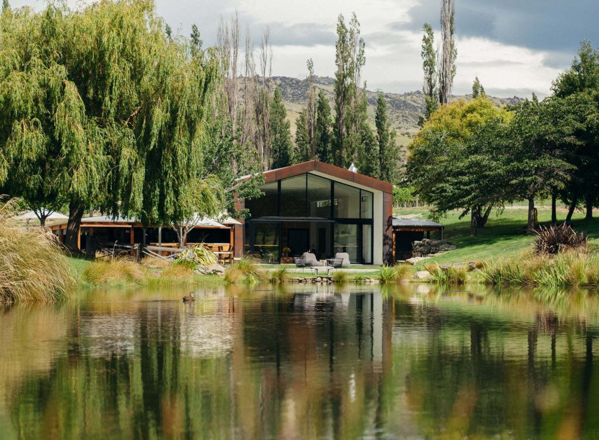 The modern Cloudy Bay Shed, an elegant Central Otago cellar door with corten steel and expansive windows, offers stunning lakeside views.