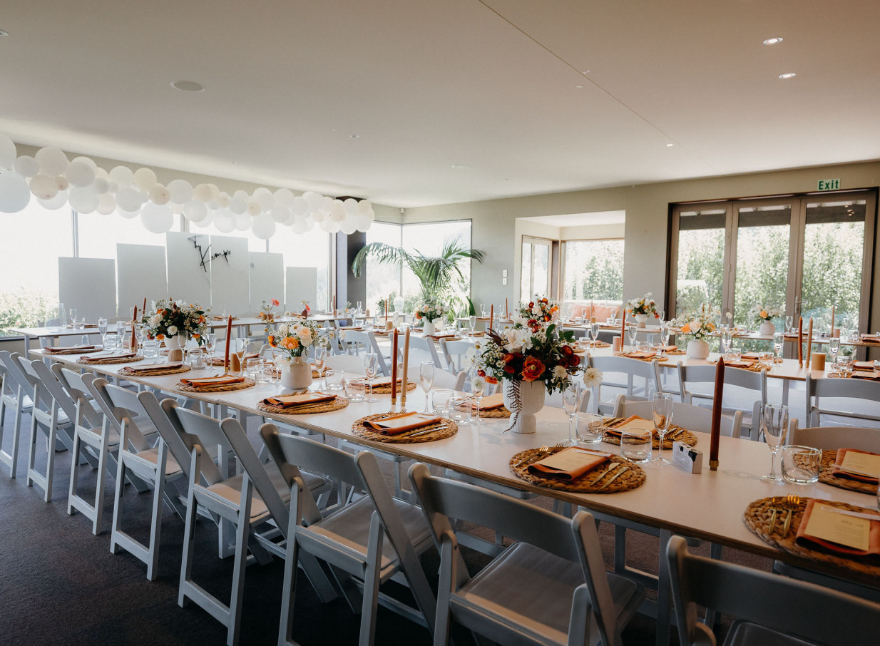 Waipuna Estate, Christchurch, offers a refined reception space with long tables, florals, and natural tones for events.
