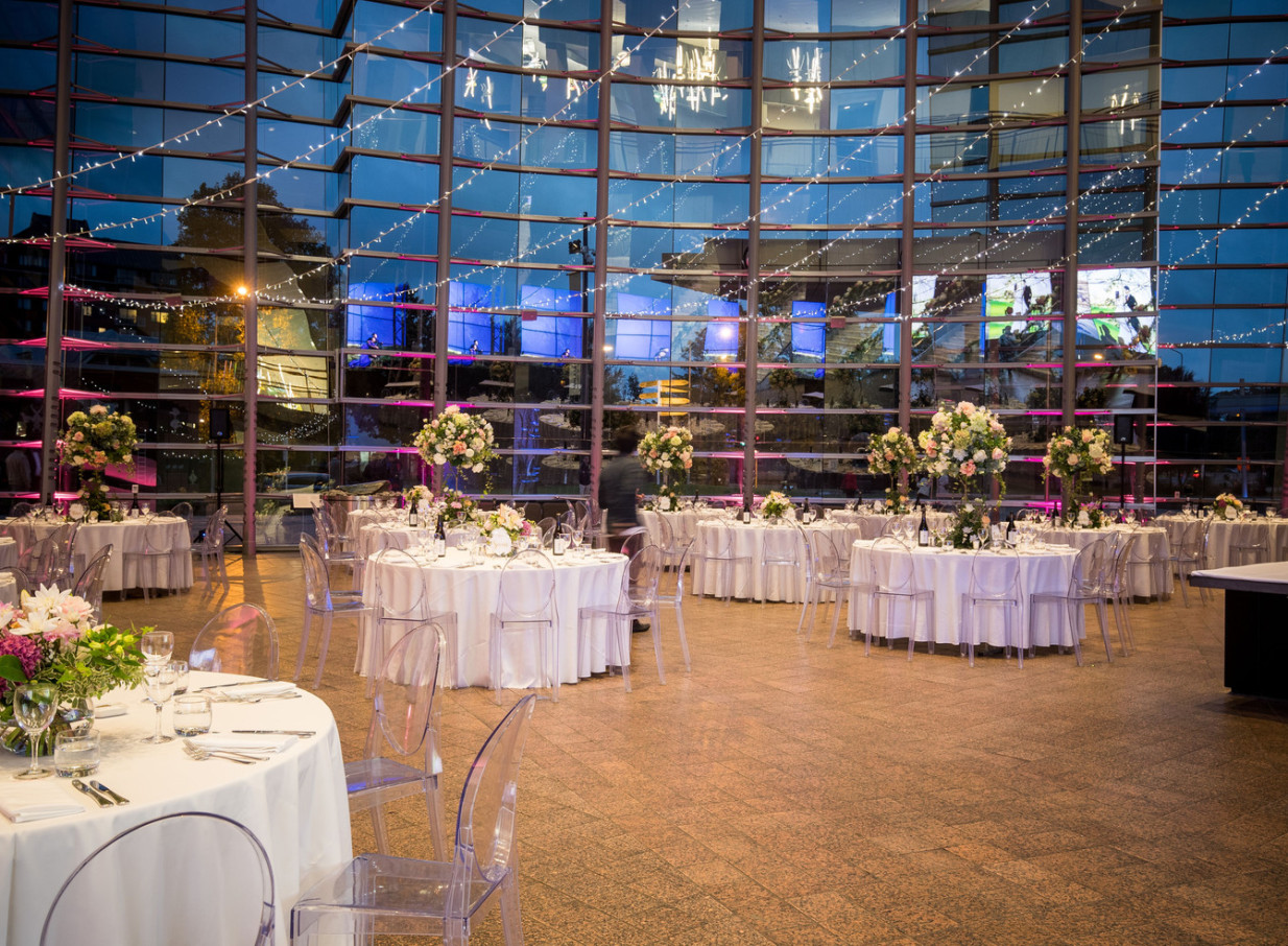 An elegant seated dinner within the dramatic glass-walled foyer of Christchurch Art Gallery Te Puna o Waiwhetū.