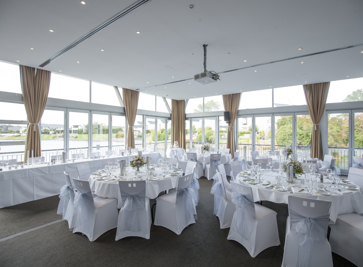 Peppers Clearwater in Christchurch offers a modern, elegant reception room with floor-to-ceiling windows providing tranquil lake views.