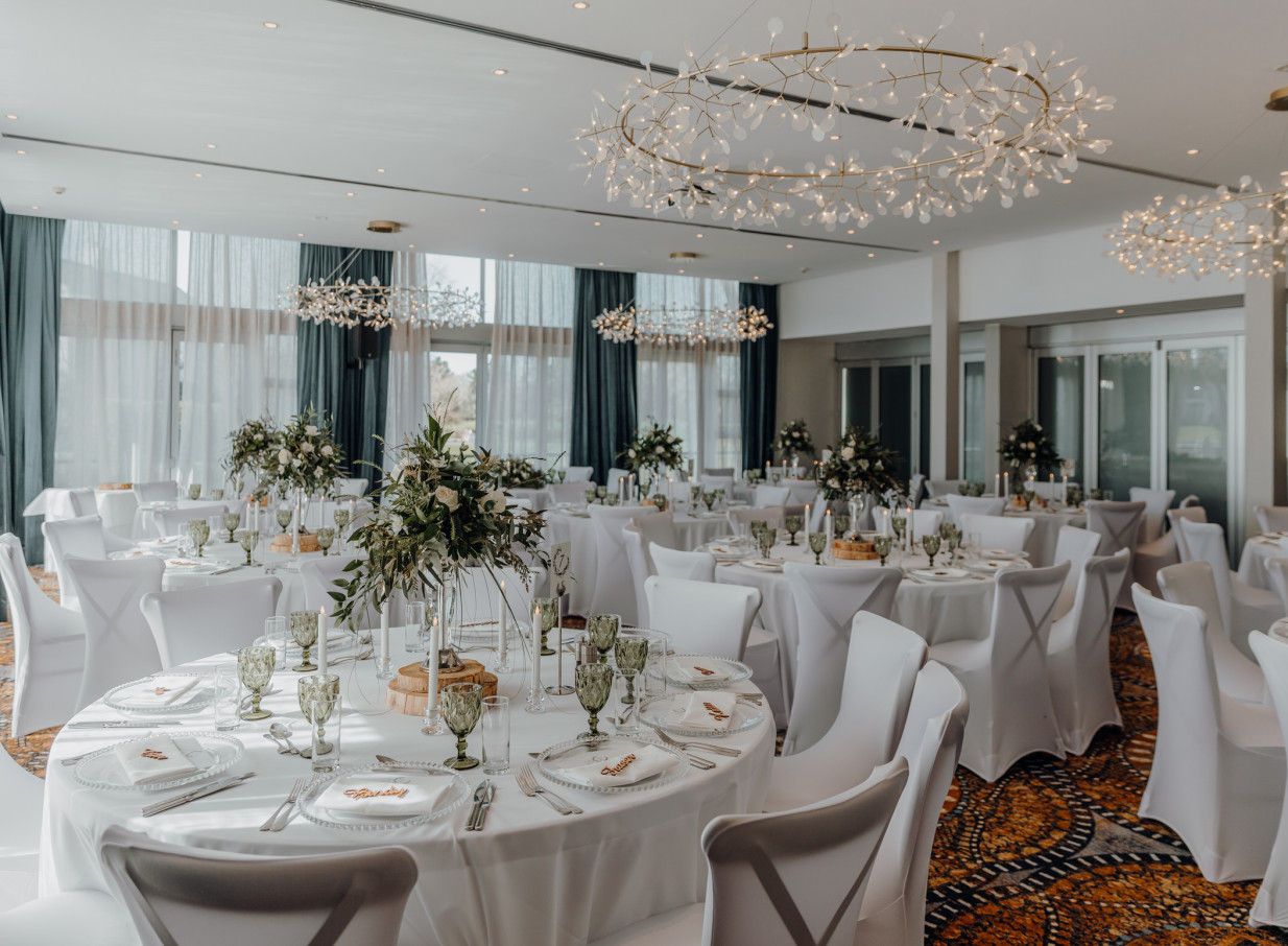 An elegant, modern dining room setup with floor-to-ceiling windows at Peppers Clearwater Resort, Christchurch.