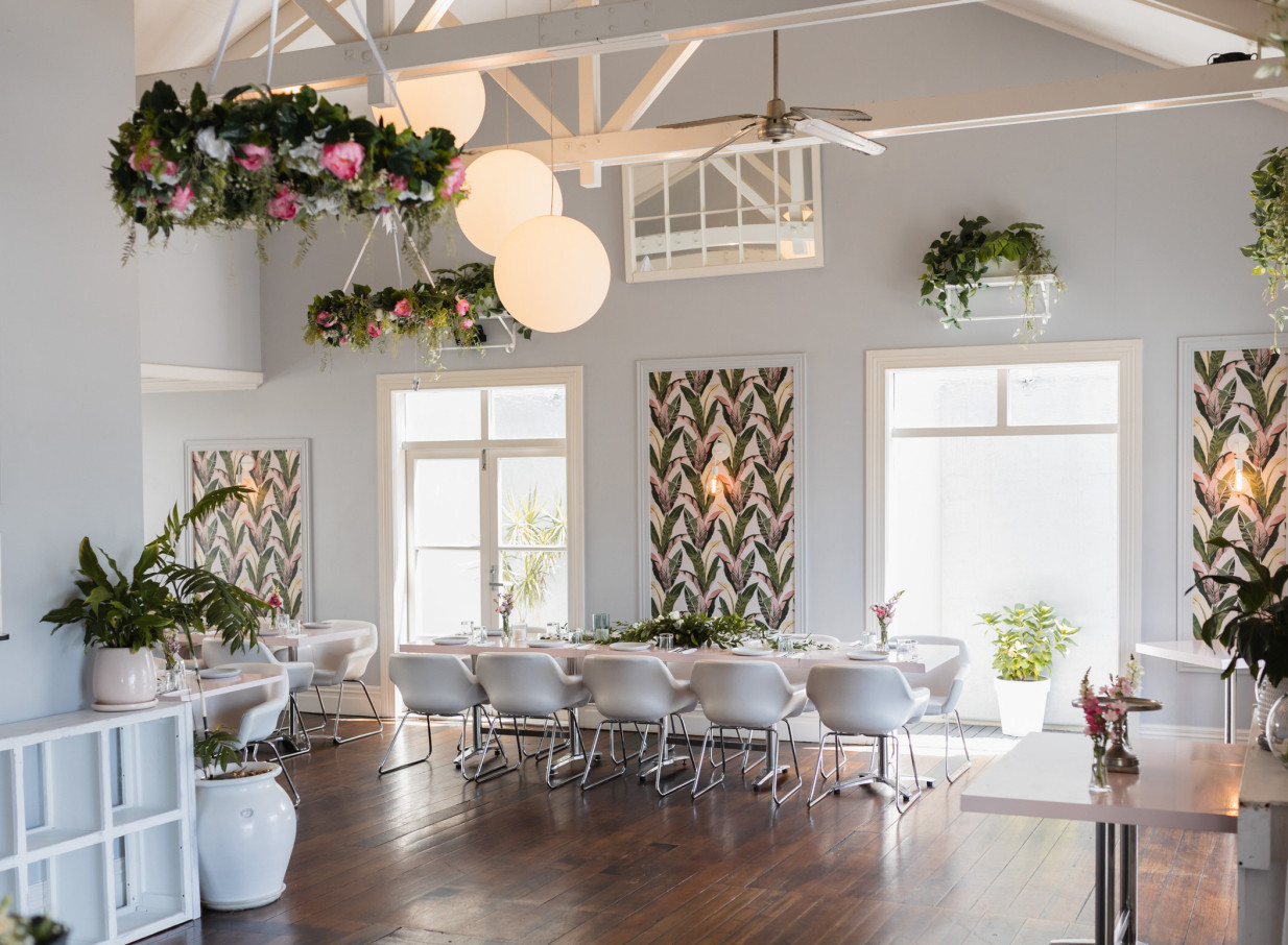 Moxie's elegant dining room in a beautifully restored Auckland villa, set for an event with floral chandeliers.