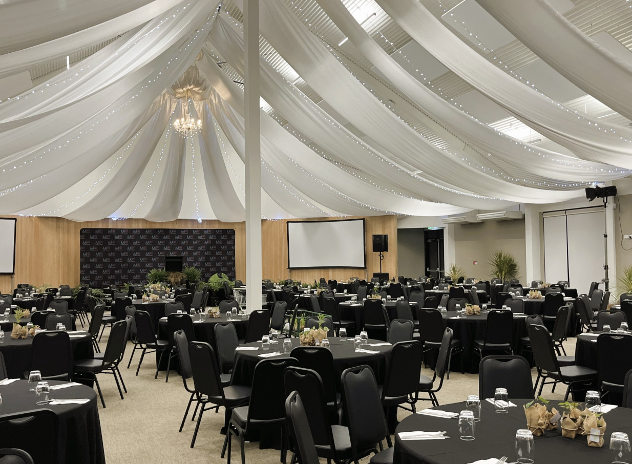 Hamilton Gardens in Hamilton offers a modern and versatile event space with elegant ceiling draping for a banquet setup.
