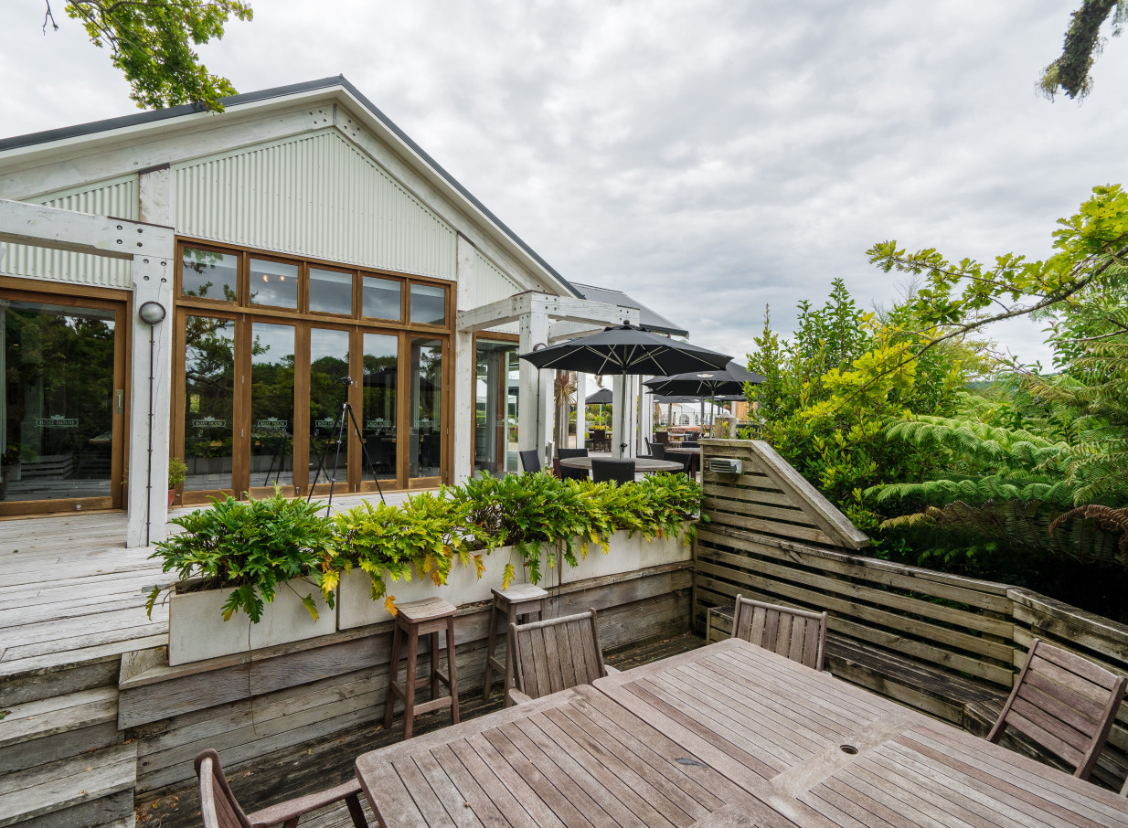 An outdoor dining area at The Boat House, an architecturally designed, coastal-inspired venue in Auckland.