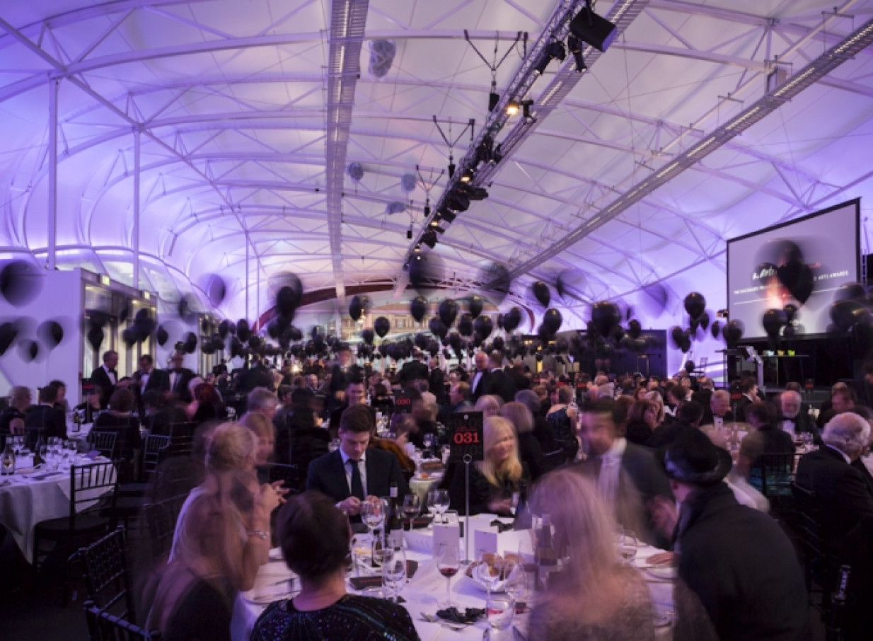 Guests at a large awards dinner inside The Cloud, Auckland's distinctive modern venue with an arched ceiling.