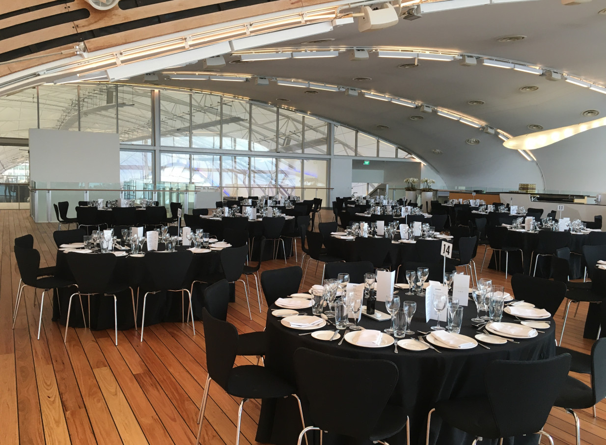 The Cloud, Auckland's modern, curved event space, features elegant dinner setups and expansive waterfront views.