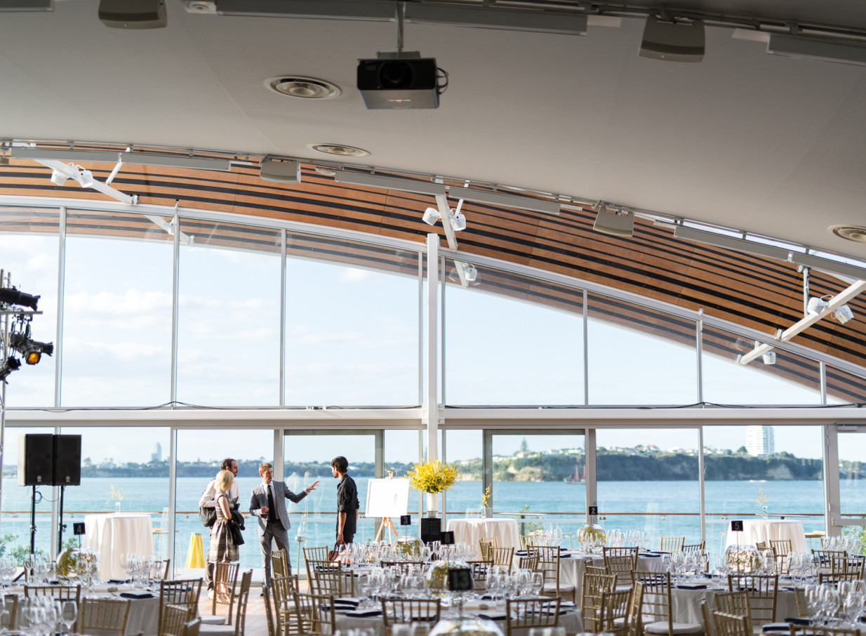 A modern, unique event space at The Cloud, Auckland, set for a banquet with panoramic waterfront views.