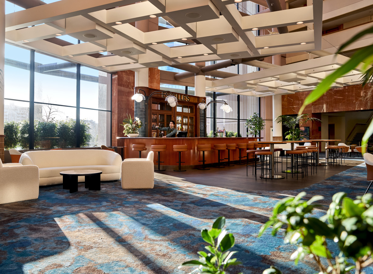 The chic, atrium lobby bar and lounge at Grand Millennium Auckland, featuring modern design and abundant natural light.