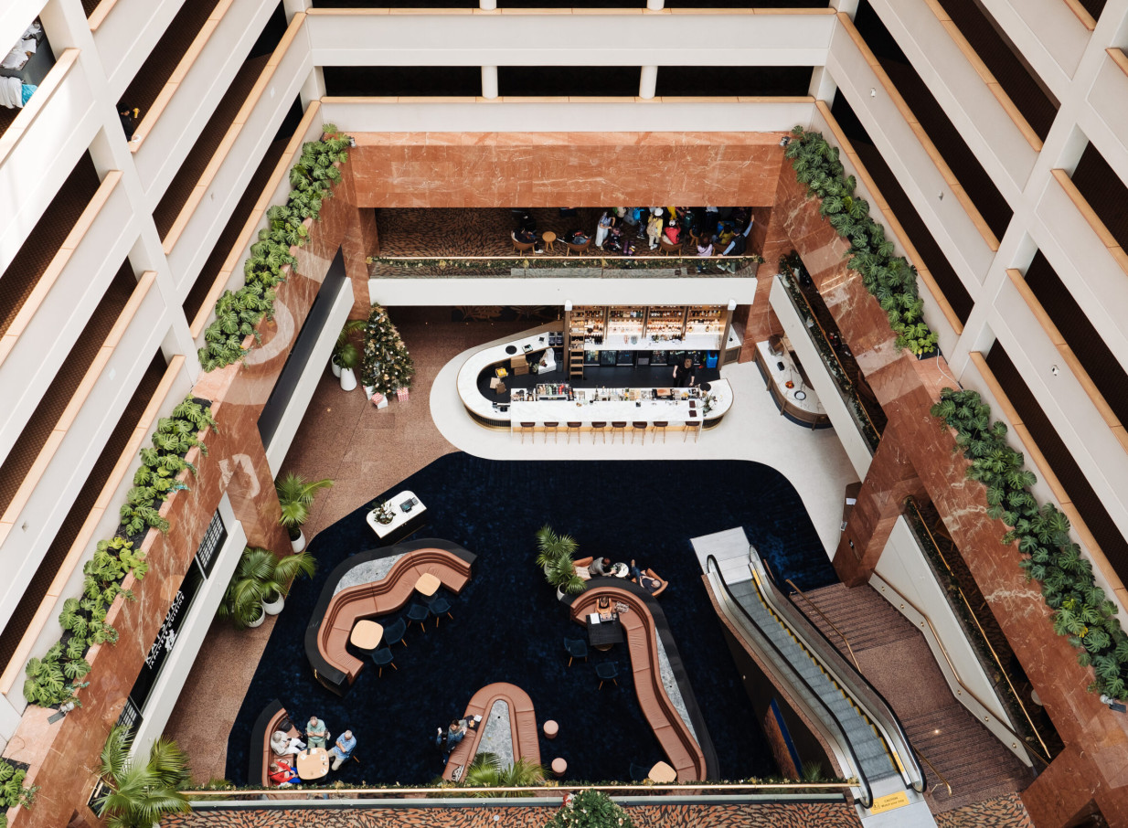An aerial view shows the modern, chic atrium lobby and Aviary Cocktail Bar at Grand Millennium Auckland.